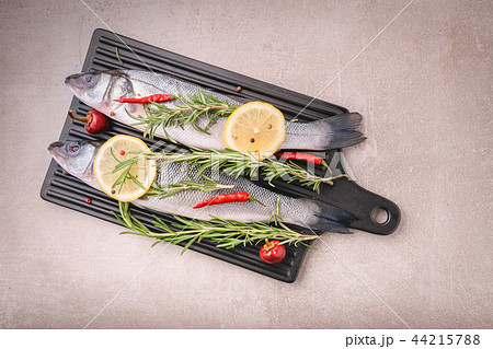 Raw sea bass fish with herbs and spices Raw sea bass fish with herbs and spices 44215788