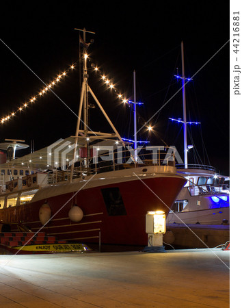 Night view of illuminated ships in port Night view of illuminated ships in port 44216881