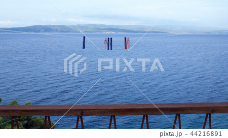 Clothespins hanging on clothesline and sea (3) 44216891