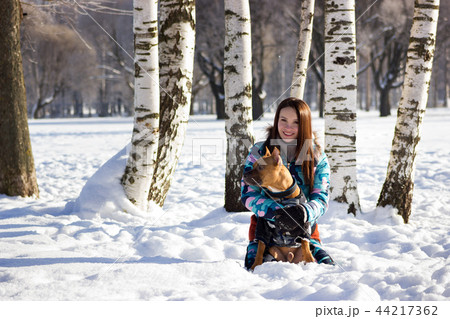 Adorable girl with her dog walks in park 44217362