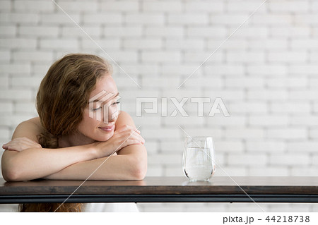 Young woman in joyful postures with jug and glass Young woman in joyful postures with jug and glass 44218738