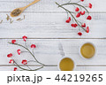 Tea and tea leaves on wooden spoon 44219265