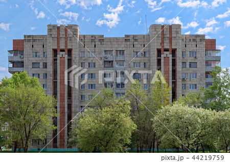 Old apartment house against cloudy blue sky 44219759