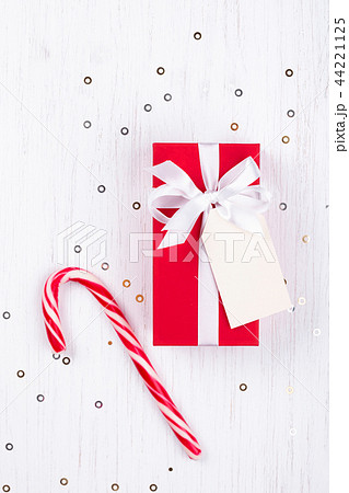 Christmas gift box wrapped in red gift paper. 44221125