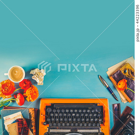 Workspace with vintage orange typewriter Workspace with vintage orange typewriter 44223396