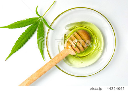 Cannabis honey and a dipper spoon isolated Cannabis honey and a dipper spoon isolated 44224065