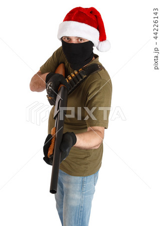 robber in black mask and cap of Santa Claus with shotgun isolated 44226143