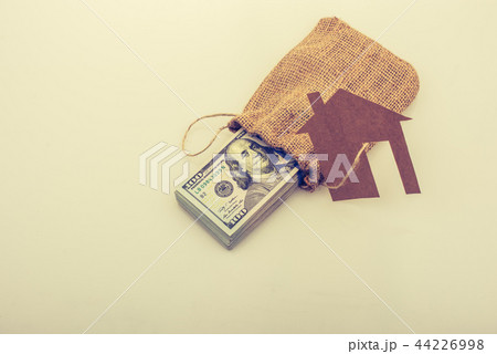 Paper house beside US dollar banknote 44226998