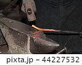 Making the horseshoe from heated red rod 44227532