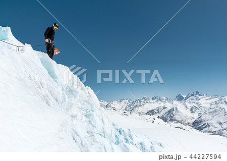 Mountain guide candidate training ice axe and rope skills on a glacier in the North Caucasus Mountain guide candidate training ice axe and rope skills on a glacier in the North Caucasus 44227594