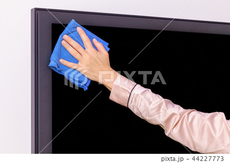 Hand with a rag wiping the TV screen 44227773