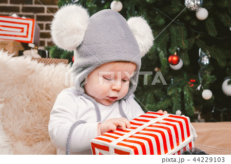 Subject children christmas new year. Caucasian little funny baby boy 1 year old sitting sleigh bear Subject children christmas new year. Caucasian little funny baby boy 1 year old sitting sleigh bear 44229103