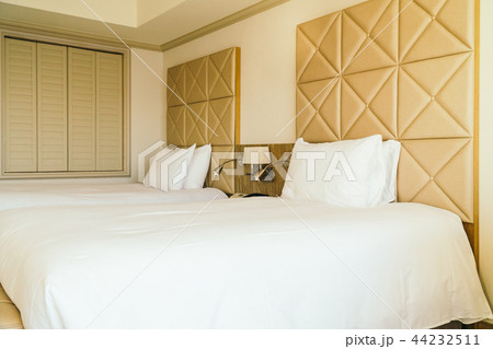 White comfortable pillow on bed decoration in hotel bedroom White comfortable pillow on bed decoration in hotel bedroom 44232511