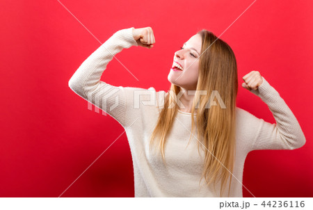 Powerful young woman in a success pose 44236116