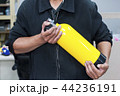 Unidentified people holding yellow oxygen tank. 44236191