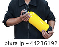 Unidentified people holding yellow oxygen tank. 44236192