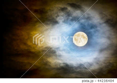 Full moon over dark cloudy sky Full moon over dark cloudy sky 44236404