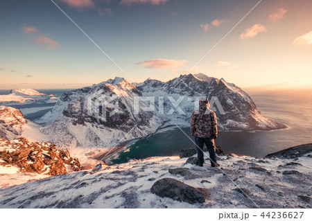 Man mountaineer standing on snowy mountain 44236627