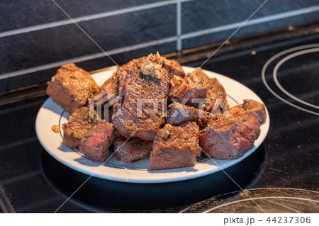 Beef steak slices with garlic on white plate 44237306