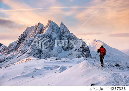 Mountaineer man climbs on top snowy mountain 44237328