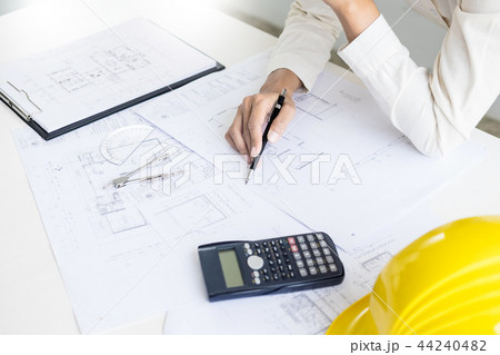 Close-up Of Person's engineer Hand Drawing Plan On Blue Print wi Close-up Of Person's engineer Hand Drawing Plan On Blue Print wi 44240482