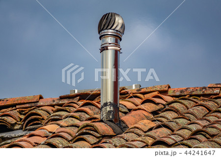 Aluminum chimney over old red tile roof Aluminum chimney over old red tile roof 44241647
