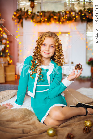 Cute little girl near a Christmas tree 44243738