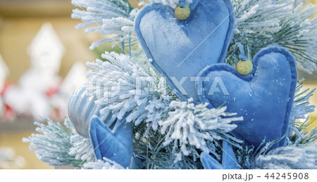 Decorative snow-covered Christmas tree decorated with decorative Decorative snow-covered Christmas tree decorated with decorative 44245908