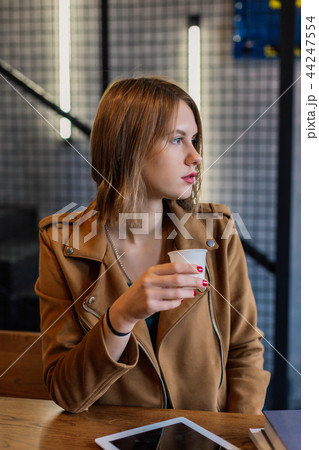 Portrait of a very pretty girl with a tablet in a Portrait of a very pretty girl with a tablet in a 44247554