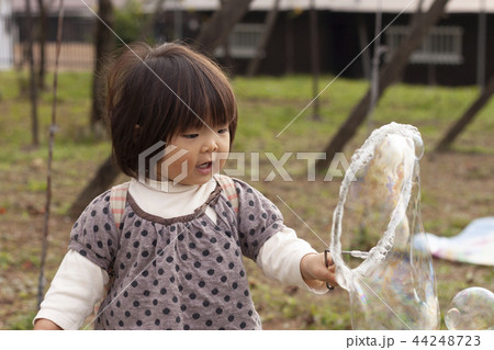 シャボン玉で遊ぶ女の子 44248723
