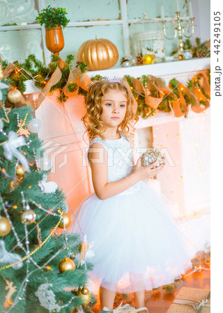 Cute little girl near a Christmas tree Cute little girl near a Christmas tree 44249105