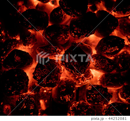 Flaming hot charcoal briquettes in detail 44252081