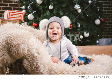 Subject children christmas new year. Caucasian little funny baby boy 1 year old sitting sleigh bear Subject children christmas new year. Caucasian little funny baby boy 1 year old sitting sleigh bear 44252419