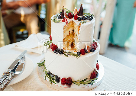 Beautiful cake covered with icing cream, summer berries on the top. Beautiful cake covered with icing cream, summer berries on the top. 44253067