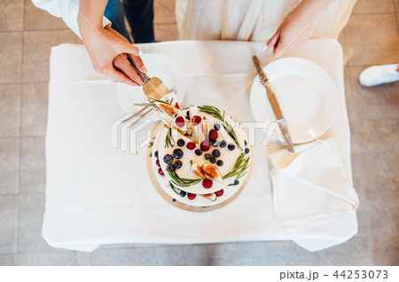 Beautiful cake covered with icing cream, summer berries on the top. 44253073