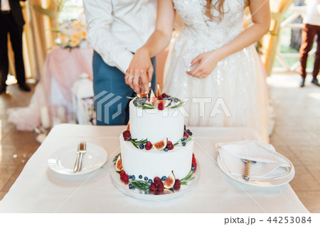 Beautiful cake covered with icing cream, summer berries on the top. Beautiful cake covered with icing cream, summer berries on the top. 44253084