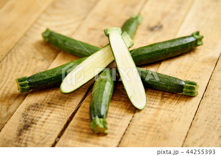 delicious and fresh baby zucchini on an old wooden table 44255393