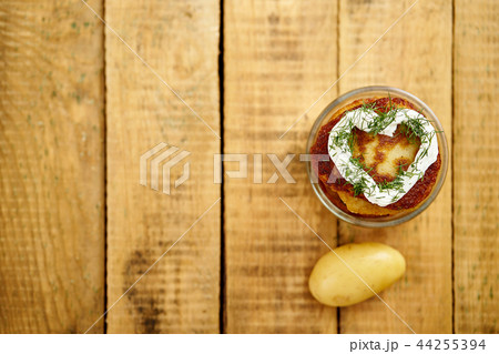 small bowl with delicious potato pancakes on an old wooden table 44255394