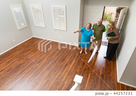 Real Estate Agent Shows Senior Couple A New Home Real Estate Agent Shows Senior Couple A New Home 44257231