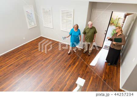 Real Estate Agent Shows Senior Couple A New Home 44257234