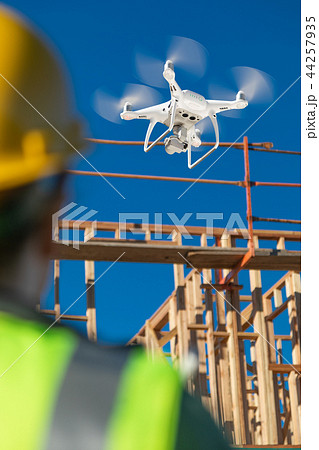 Female Drone Pilot Inspects Construction Job Site Female Drone Pilot Inspects Construction Job Site 44257935