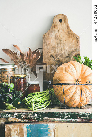 Autumn food ingredients and utensils over cupboard chest 44258062