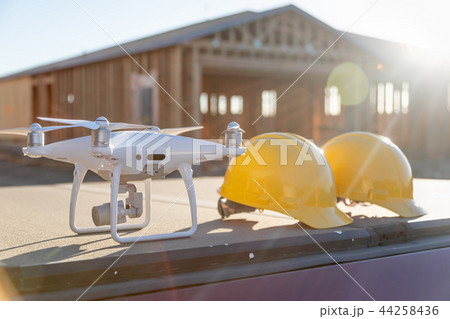 Drone Next to Hard Hats At Construction Work Site Drone Next to Hard Hats At Construction Work Site 44258436