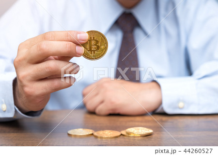 Businessman holding bitcoin. Crypto currency Businessman holding bitcoin. Crypto currency 44260527