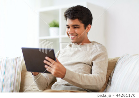 smiling man with tablet pc at home 44261170