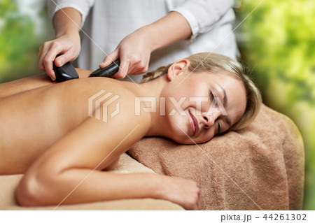 close up of woman having hot stone massage in spa close up of woman having hot stone massage in spa 44261302