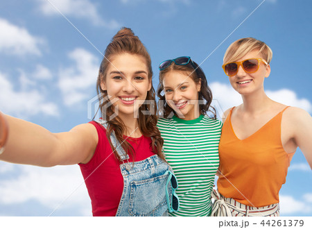 happy female friends in sunglasses taking selfie 44261379