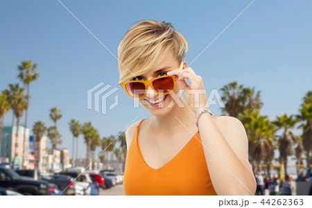 portrait of smiling young woman in sunglasses 44262363