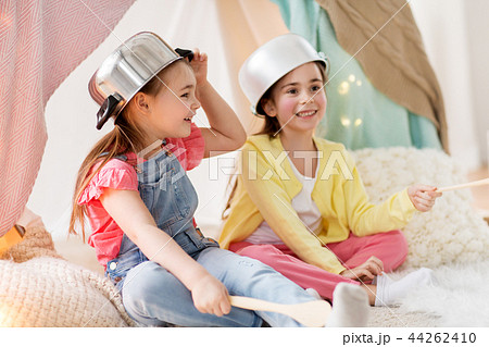 girls with kitchenware playing in tent at home 44262410