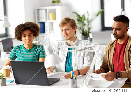 happy creative workers with laptops at office 44262411